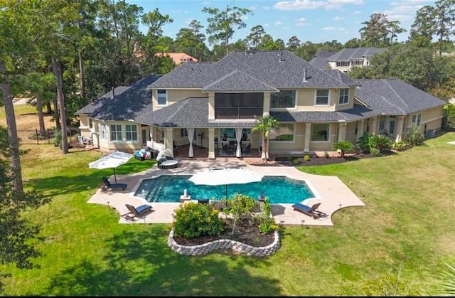 back of house featuring a lawn and a patio