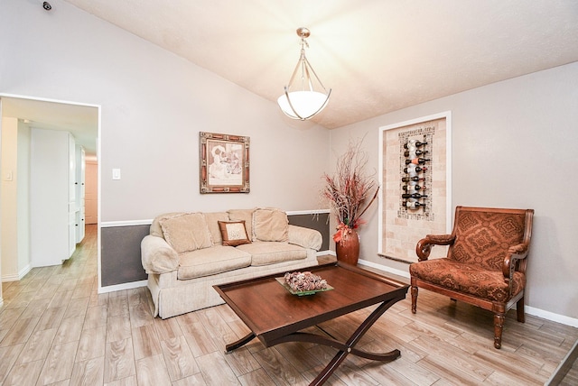 living room with light wood-type flooring and lofted ceiling