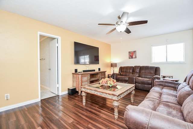 living room featuring dark wood-type flooring and ceiling fan