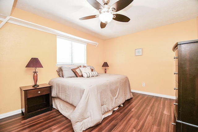 bedroom with ceiling fan and dark hardwood / wood-style flooring