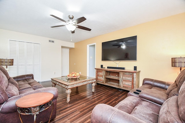 living room featuring ceiling fan and dark hardwood / wood-style flooring