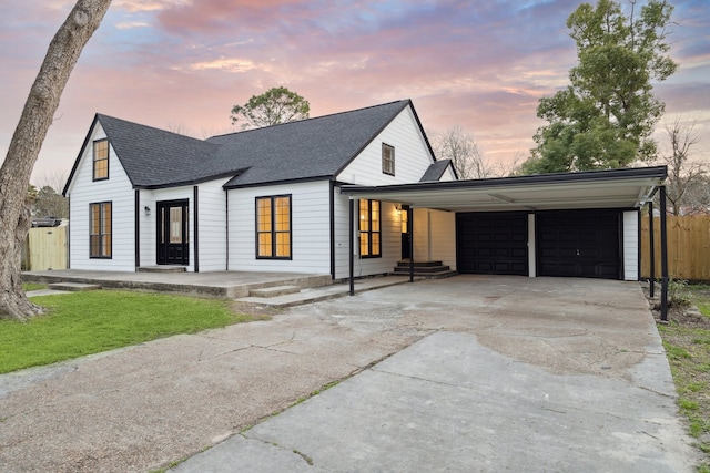 modern inspired farmhouse featuring a carport and a garage