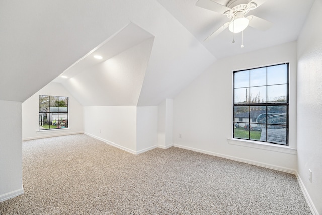 bonus room featuring vaulted ceiling, carpet, and ceiling fan