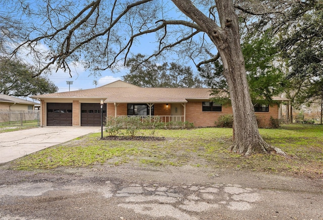 single story home featuring a porch, a garage, brick siding, fence, and driveway