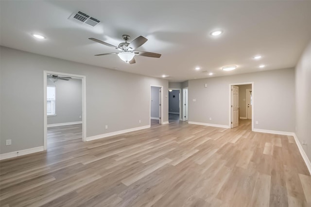 unfurnished room featuring light wood-type flooring, visible vents, baseboards, and recessed lighting