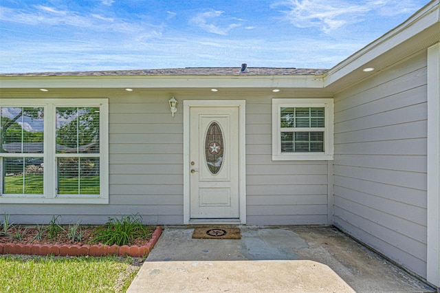 property entrance featuring a patio area