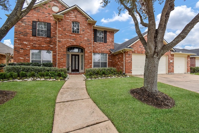 traditional-style home with a garage, concrete driveway, brick siding, and a front lawn