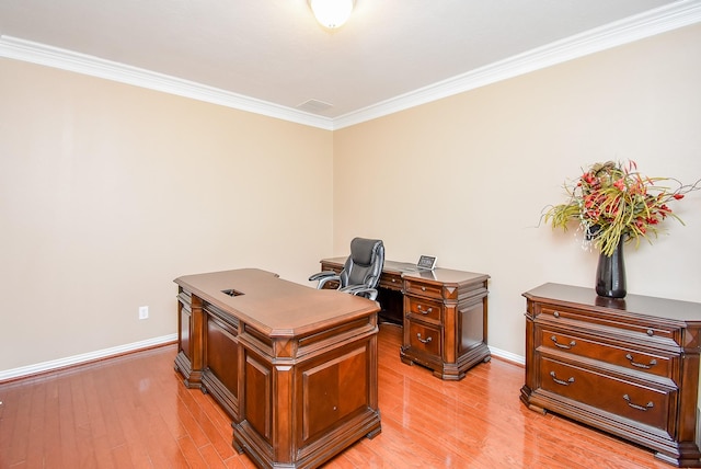 office space with light wood-type flooring, crown molding, and baseboards