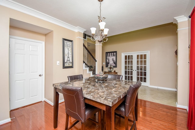 dining space with french doors, stairway, wood finished floors, a chandelier, and baseboards