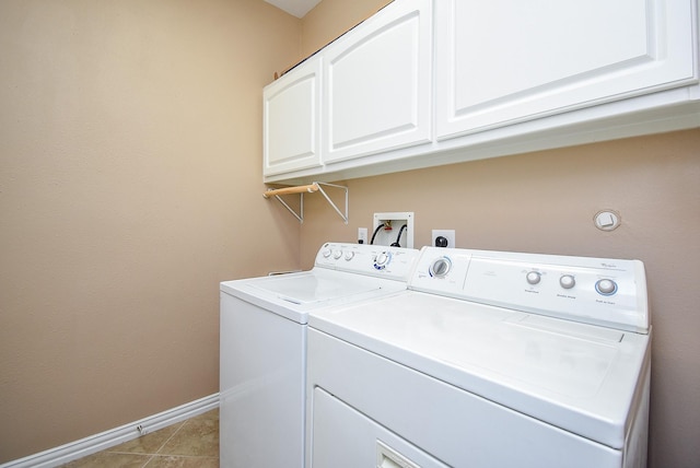 washroom featuring washing machine and dryer, cabinet space, baseboards, and light tile patterned flooring