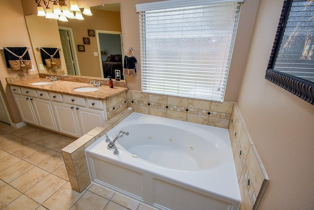 bathroom with tile patterned flooring, a sink, a whirlpool tub, and double vanity