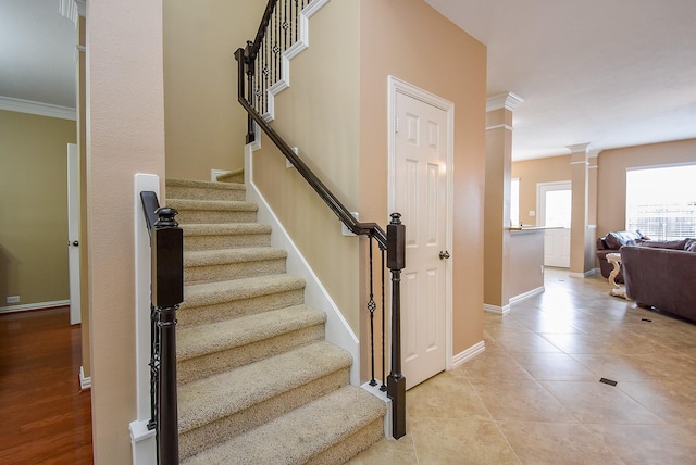 stairs with tile patterned flooring, decorative columns, baseboards, and crown molding