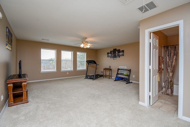 workout room featuring visible vents, ceiling fan, light carpet, and baseboards