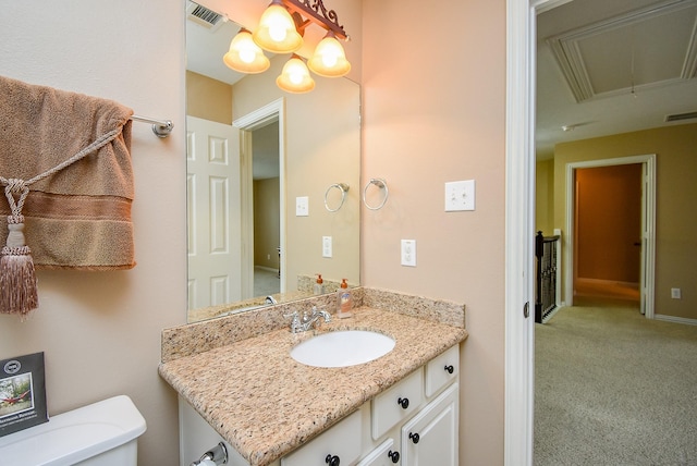 half bath featuring visible vents, vanity, and toilet