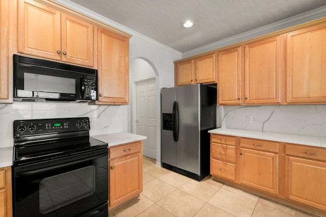 kitchen with ornamental molding, light tile patterned floors, black appliances, and backsplash