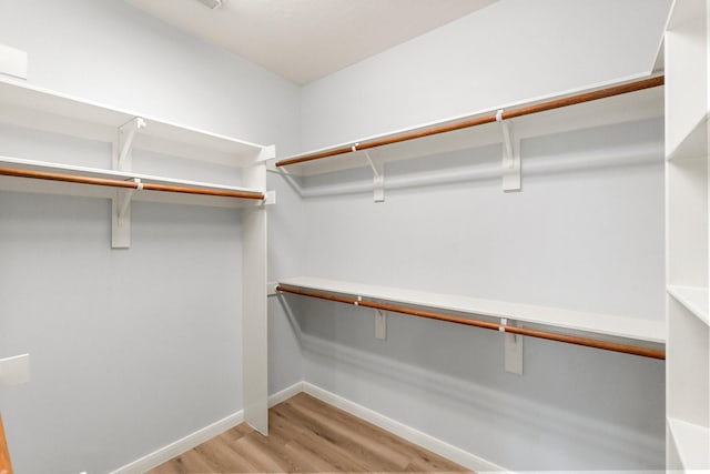 spacious closet with light hardwood / wood-style floors