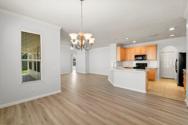 kitchen with pendant lighting, black appliances, light brown cabinets, kitchen peninsula, and ornamental molding