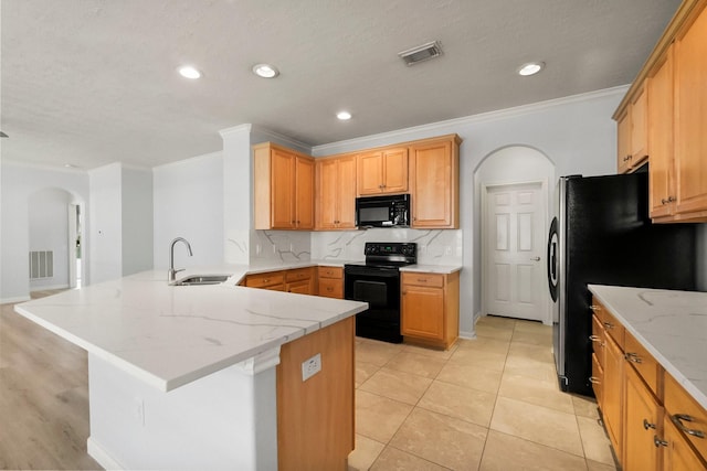 kitchen with sink, black appliances, ornamental molding, and tasteful backsplash