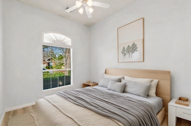 bedroom featuring hardwood / wood-style flooring and ceiling fan