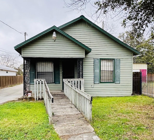 bungalow-style home with a front lawn