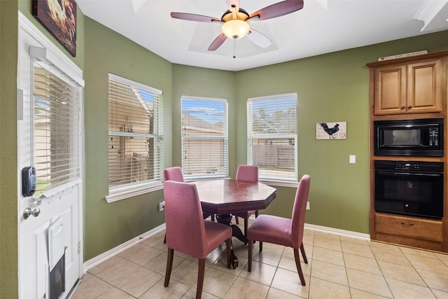 tiled dining space with ceiling fan