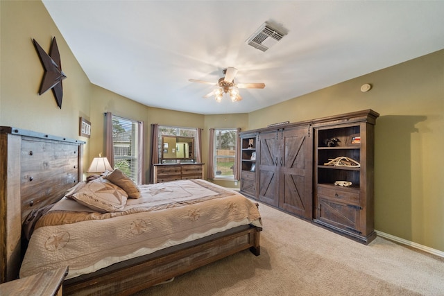 bedroom with ceiling fan and light colored carpet