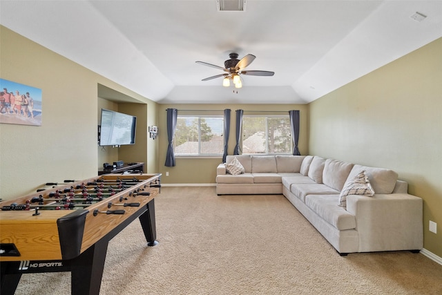 recreation room with a raised ceiling, ceiling fan, and carpet flooring