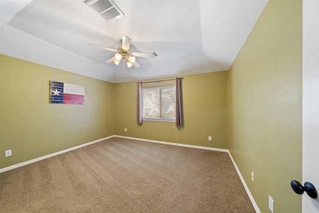 carpeted spare room featuring lofted ceiling and ceiling fan