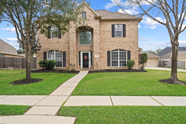 view of front of property featuring a garage and a front yard