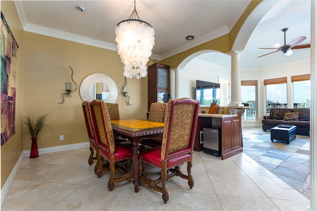 dining space featuring decorative columns, crown molding, ceiling fan with notable chandelier, and light tile patterned floors