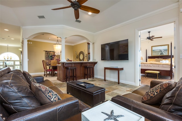 living room featuring crown molding, ceiling fan with notable chandelier, and ornate columns