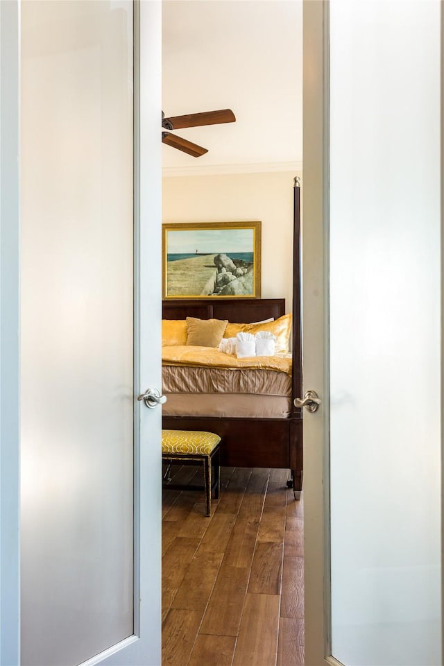 corridor with ornamental molding and dark hardwood / wood-style flooring