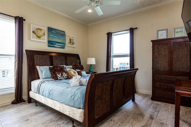 bedroom with crown molding, ceiling fan, and light hardwood / wood-style flooring