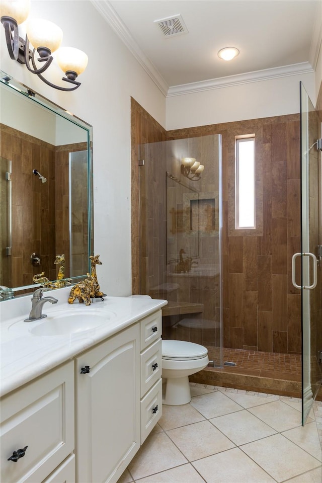 bathroom with tile patterned flooring, crown molding, a shower with door, and toilet