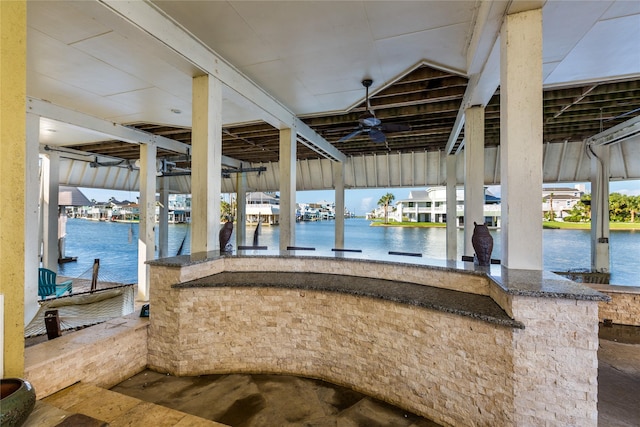 dock area with a water view and an outdoor bar