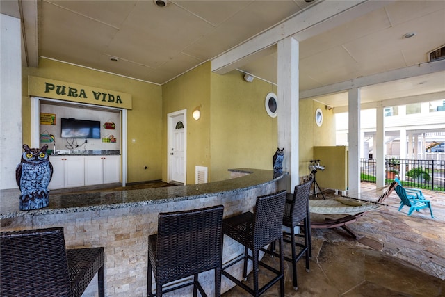 view of patio featuring an outdoor bar