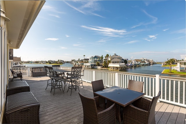 wooden terrace featuring a water view