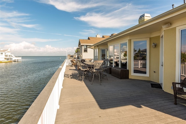 wooden deck featuring a water view