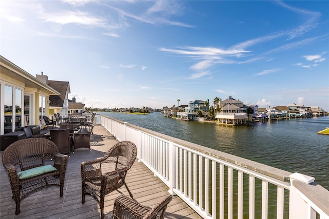 wooden terrace featuring a water view