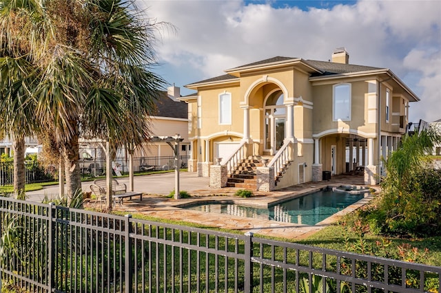 back of house featuring a fenced in pool and a patio area