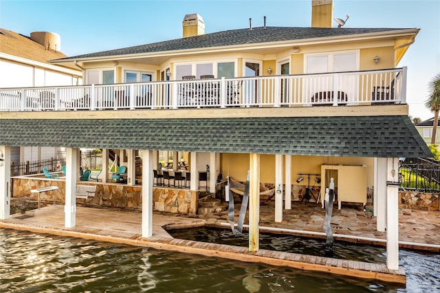 rear view of property with a water view