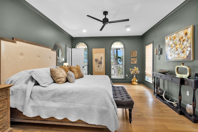 bedroom with multiple windows, light hardwood / wood-style flooring, and ornamental molding