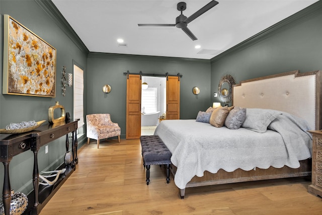 bedroom with crown molding, light hardwood / wood-style floors, a barn door, and ceiling fan