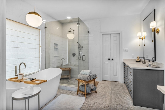 bathroom featuring vanity, shower with separate bathtub, and tile patterned flooring