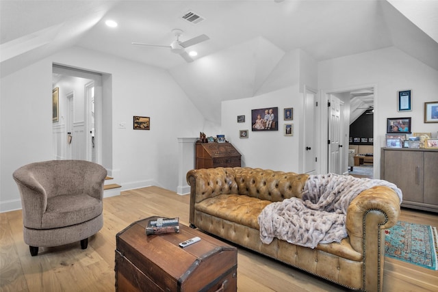 living room featuring ceiling fan, vaulted ceiling, and light hardwood / wood-style flooring