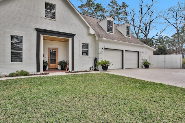 view of front of home featuring a garage and a front lawn