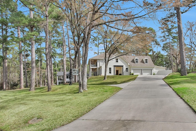 view of front of property with a garage and a front lawn