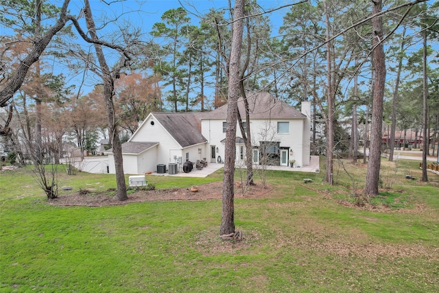 view of front of property with central AC unit, a patio area, and a front yard