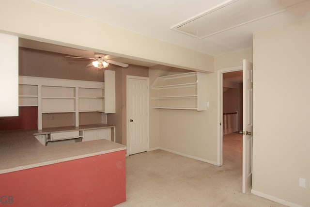 kitchen with white cabinetry, light carpet, and ceiling fan