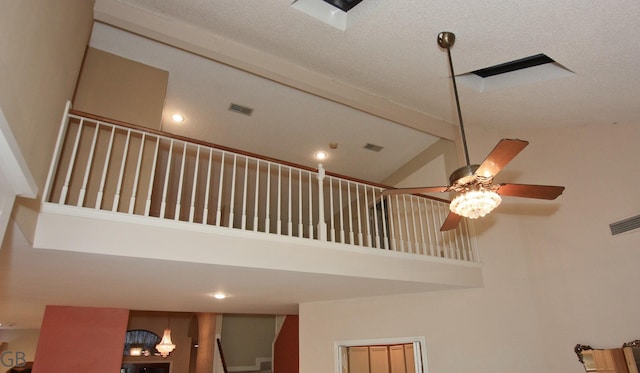 interior details featuring a textured ceiling and beamed ceiling